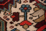 A hand-knotted floral blossom in powder blue and red on the full wool pile of a Persian Heriz.