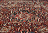 Close-up of the vintage Heriz carpet's serrated leaf and floral bud motifs in gem-like tones.