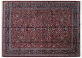 Corner of a vintage Kashan carpet showing its navy floral border and burgundy field.