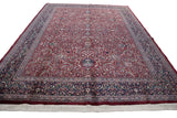 Angled perspective of a vintage Indian Kashan carpet, displaying its full length and white fringe.