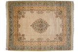 Vintage Bulgarian Kerman carpet with a floral medallion and spandrels on an open ivory field.