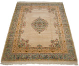 Angled view of a fine vintage Bulgarian Kerman carpet, showing its full floral medallion and Rococo style borders.