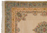 Fine floral spandrel and Rococo-style borders in powder blue and saffron on a vintage carpet.