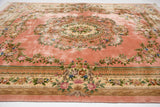 Plush, silk-like dusty pink field and ornate floral border of a vintage Chinese Aubusson carpet.
