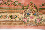 Plush pink and ivory Aubusson style border with detailed roses, foliage, and patterned bands.