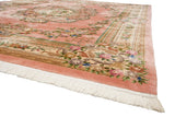 Plush white fringe, dusty pink border, and floral motifs of a Chinese Aubusson rug.