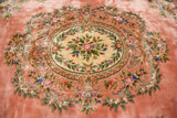 Vintage Chinese Aubusson design carpet's ornate roses and foliage in dusty pink and ivory.