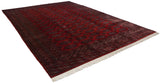 Angled view of a vintage Pakistani rug with cherry red and navy blue Turkmen gul motifs.