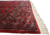 Plush pile, intact side cord, and ivory fringe of a vintage Pakistani Turkmen design carpet.