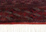 Secured end of a vintage Pakistani rug, showing detailed borders and clean, hand-knotted white fringe.