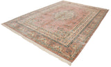 Kerman carpet corner showing dusty rose field, detailed floral vinery, Safavid dragon border.
