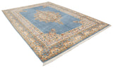 Sky blue field of Indian Kerman rug with scalloped medallion edge and Rococo floral border.
