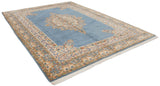 Vintage Indian Kerman carpet corner with intricate floral borders, sky blue field, and fringe.