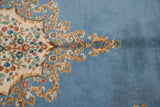 Rococo vinery and blush floral sprays contrasting sky blue and ivory fields, Kerman rug.