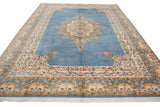 Sky blue field and ivory Safavid dragon motif border with fringe on Kerman carpet.