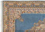 Corner of Indian Kerman design rug with scalloped sky blue field and Rococo stylized vinery borders.