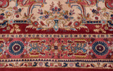 Cherry red border with intricate floral vinery meeting an ivory field on this Indian Sarouk rug.
