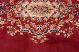 Elaborate floral vinery in ivory, blue, pink on cherry red Sarouk carpet.