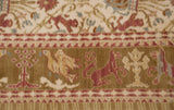 Hand-knotted lion and bird motifs in copper and gold within the pictorial border of a Spanish carpet.