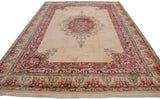 Vintage Indian Kerman carpet with ivory field, scalloped raspberry red medallion, Rococo floral borders.