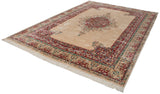 Vintage Kerman rug with vibrant floral center medallion, scalloped contour, raspberry and green vines.
