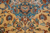 Intricate arabesques and floral details in sky blue, navy, and rust on a plush gold pile.