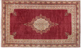 Kerman rug corner with raspberry field, inwardly scalloped ivory floral spandrel and dragon border.