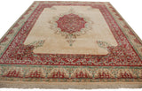 Raspberry red and ivory floral borders with fringe on the vintage Indian Kerman rug.