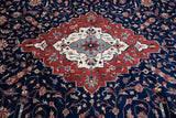 Angled detail of the classic center medallion in red, ivory, and powder blue on the navy field.