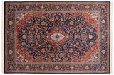 Kashan design rug corner with elaborate navy blue arabesque border and brick red spandrel.
