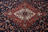 Delicate scrolling vinery and blossoms on a navy blue field with cherry red border detail.