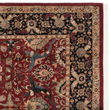Intricate corner construction of a vintage Agra carpet with a floral border and original red selvage.