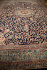 Vintage Indian Ardebil carpet with intricate navy thousand flower field and seafoam border.