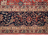 Interconnected Islimis and scrolling vinery on the navy blue border of a vintage Agra carpet.