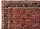Corner detail of a vintage Agra carpet showing the navy Islimis border and red Samovar field.