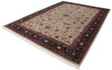 Vintage Agra carpet from a dimensional angle, showing the scrolling vinery and deep navy floral border.