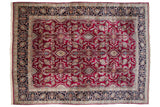 Vintage Kerman carpet with a floral medallion pattern in cherry red and a wide navy blue border.