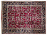 Corner view of a vintage Kerman carpet with a navy floral palmette border and plush cherry red field.