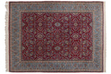 Vintage Kerman carpet with a cherry red field of floral medallions and a wide sky blue border.