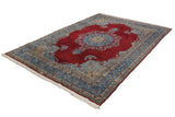 Vintage Kerman carpet: cherry red field, blue Safavid-inspired meandering vine border, fringe.