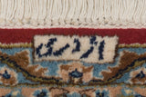 Weaver signature on vintage Kerman carpet, showing ivory fringe and a cherry red border.