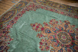 Intricate Rococo-style medallion corner and wide floral borders on a lush pale ocean green Kerman rug.