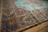 Lush pile and detailed Rococo-style border on a vintage Persian Kerman carpet corner.
