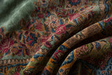 Close view of the plush wool pile and Rococo florals on a vintage Kerman rug.