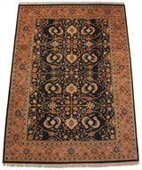Vintage Pakistani rug corner, showing terracotta floral vine border and navy blue Herati field.