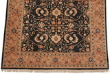 Vintage Pakistani rug corner, terracotta border with floral vines, blue blooms, and fringe.