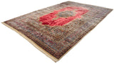 Full length perspective of a vintage Kerman rug with a lush red field and elaborate sky blue and ivory borders.