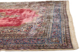 Elaborate sky blue scrolling vine border and full wool pile on a vintage Kerman Persian carpet.