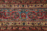 The signature Cyrus Crown insignia woven into the sky blue main border of a vintage Kerman carpet.