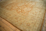 Lustrous vintage Indian Oushak carpet with copper palmettes and floral cartouche border.